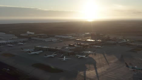 Bright-sunset-over-international-airport-in-Iceland-amid-global-lockdown,-aerial