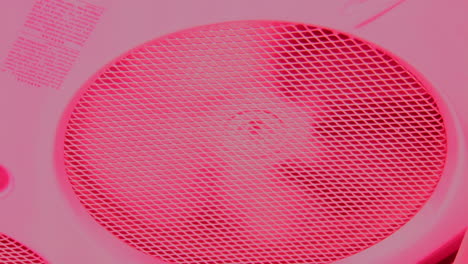 Extractor-fan-spinning-up-inside-tanning-machine-with-pink-red-light