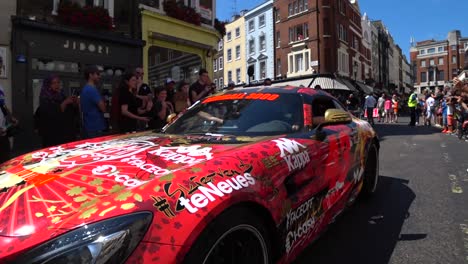 Epic-low-angle-shot-of-pimped-mercedes-gt-racing-car-in-red-presenting-on-Gumball-3000-Show-in-London