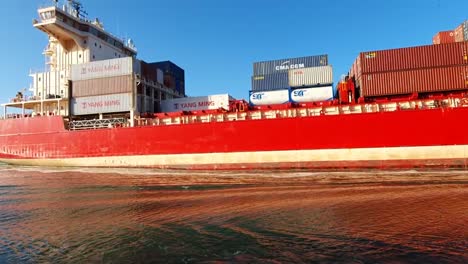 Red-container-ship-on-a-river