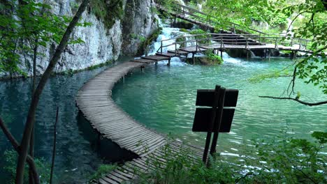 A-high-view-of-a-completely-empty-wooden-walkway-near-several-waterfalls-at-Plitvice-Lakes-National-Park-in-Croatia,-Europe