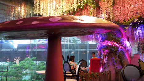 Lowering-boom-shot-of-fake-giant-mushroom-decor-in-cat-cafe