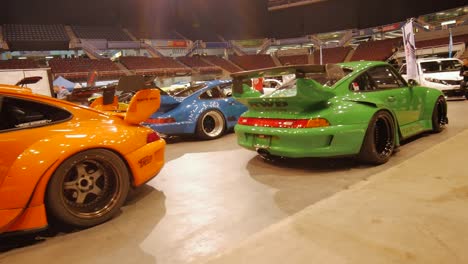 Porsche-on-the-floor-of-an-auto-show-in-Vancouver,-British-Columbia,-pan-right