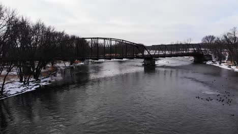 Old-Bridge-Over-Winter-Rushing-River-Drone