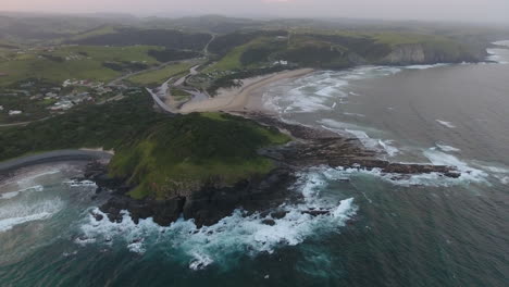 Cinematic-aerial-flying-at-sunrise-over-coast-of-East-London-South-Africa