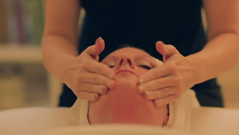 Beautiful-woman-getting-her-face-massaged-at-the-spa