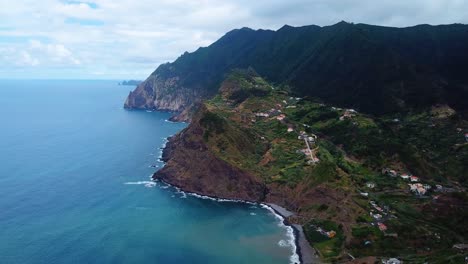 Aerial-landscape-shot-of-steep-hills-and-coast-of-atlantic-ocean-Madeira,-Portugal