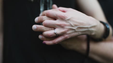 Young-couple-holding-hands-with-a-beautiful-engagement-ring