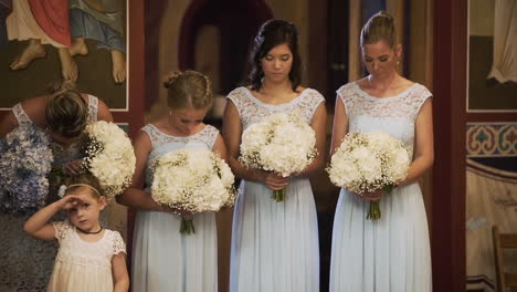 Beautiful-bridesmaids-listening-to-a-wedding-ceremony-in-a-church