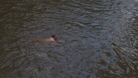 Boy-swimming-in-a-creek