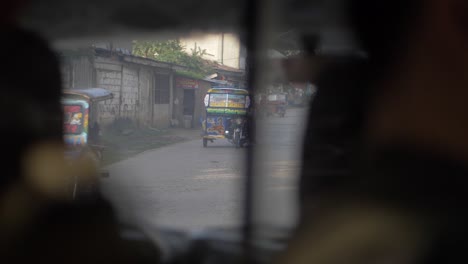 Slow-motion-view-from-the-back-seat-of-a-motorcycle-taxi-of-a-busy-street-filled-with-shoppers-and-traffic