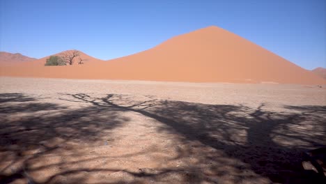 Reveal-Slomo-of-a-Large-Dune-in-Sossusvlei,-Namibia,-with-Hot-Weather-and-Blue-Sky