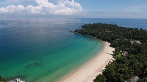 Aerial-shot-of-Surin-Beach-on-Phuket-in-Thailand,-flying-a-part-of-a-circle-in-beautiful-weather