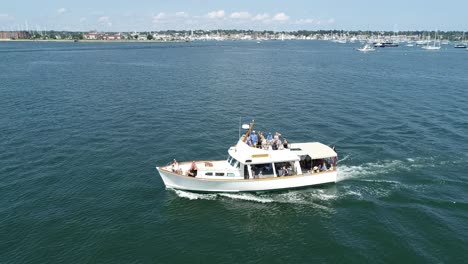 Iconic-Newport-Rhode-Island-scenery-is-enjoyed-by-a-boat-load-of-tourists-near-Ft