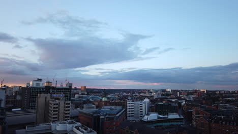Time-Lapse-of-Sunset-over-Leeds-City-Centre-with-Long-Shadows-and-Pink---Purple-Clouds-Fading-into-Darkness