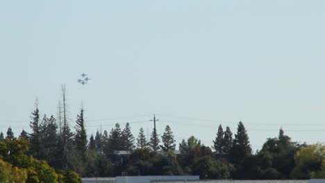 Blue-Angels-FA---18A-Fighter-Jets-Flys-in-Formation-Across-Wide-Landscape-Trees-and-Telephone-Poles