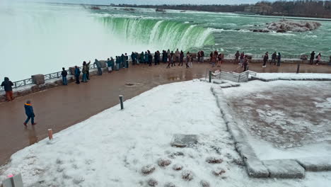 Tourist-people-looking-at-a-famous-Niagara-falls-in-winter