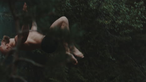 Man-diving-off-a-cliff-in-a-forest