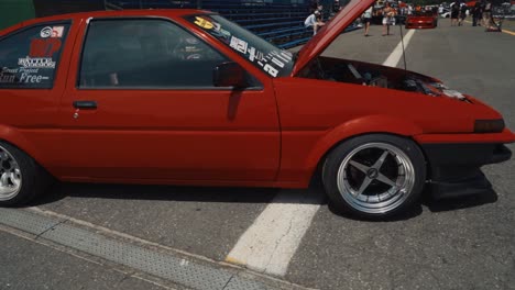 Arc-Shot-of-a-Cool-Red-Toyota-AE86-Hatchback-Show-Car