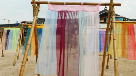 colorful-hanbok-fabric-hanging-on-traditional-korean-hanoaks-in-namsangol-hanoak-village