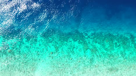 Wunderschöne-Küste-Einer-Tropischen-Insel-Mit-Blauem,-Türkisfarbenem,-Ruhigem-Wasser-Der-Lagune-über-Korallenriffen-Und-Kieselsteinen-In-Der-Karibik