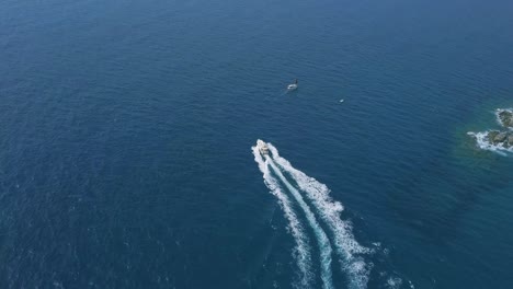 Beautiful-motorboat-sailing-in-a-wonderful-blue-sea,-small-boats-near-the-coast-in-Costa-Brava,-Spain