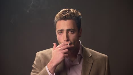 Young-male-smokes-a-cigarette