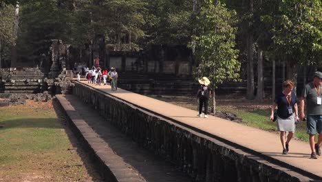 Long-Zoom-Out-of-Tourists-Leaving-a-Temple-on-the-Walkway-at-Angkor-Wat