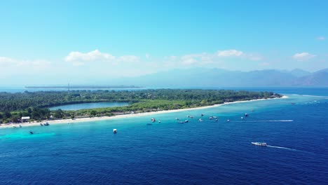 Peaceful-sea-scene-with-blue-azure-lagoon-around-white-sandy-beach-of-tropical-island-with-green-vegetation,-Indonesia