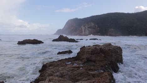 Misty-seascape-scene:-Foaming-river-bar-at-Knysna-Heads,-South-Africa
