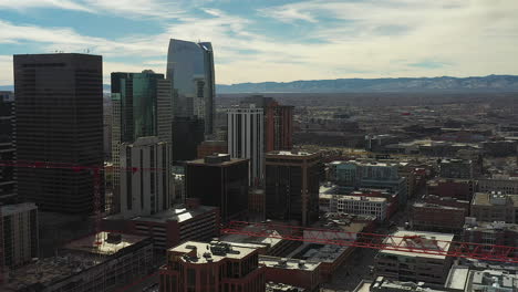Aerial-drone-footage-over-Downtown-Denver,-Colorado-and-construction-cranes