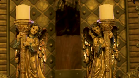 Panning-horizontal-shot-of-the-statue-of-the-candlestick-holding-the-candle-representing-two-angels