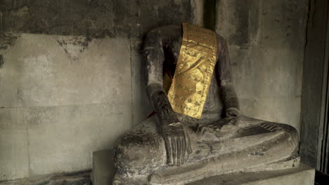 Old-stone-sculpture-of-buddhism-god-with-golden-garb
