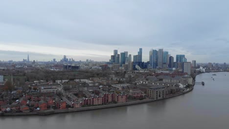 Slider-drone-shot-of-canary-wharf-London-over-thames-river
