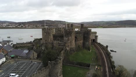 Historical-medieval-Conwy-castle-landmark-aerial-view-push-in-descending