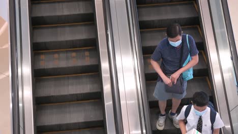 Shoppers-ride-an-automatic-moving-escalator-at-a-shopping-mall-in-Hong-Kong