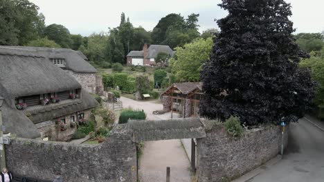 Cockington-thatched-cottage-idyllic-English-rural-countryside-village-rising-pull-back-tilt-down