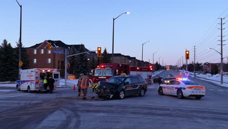 Firefighters-cleaning-up-street-at-scene-of-car-crash-in-Mississauga,-Canada