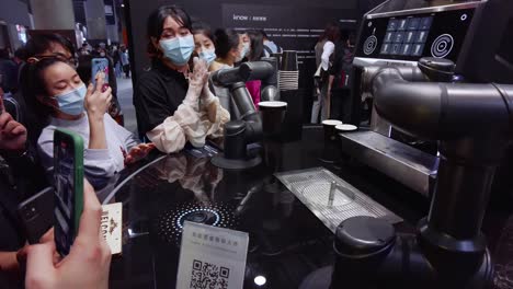 Coffee-making-Robot-barista-making-a-cup-of-coffee-in-front-of-visitors-at-kitchen-design-exhibition-in-China,-during-COVID-19-Pandemic