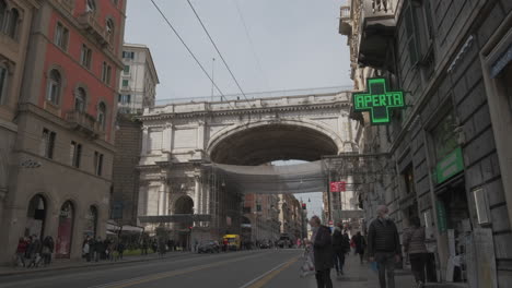 Traffic-cars-people-in-Genoa-Via-XX-Settembre-street-and-Ponte-Monumentale-Monumental-Bridge