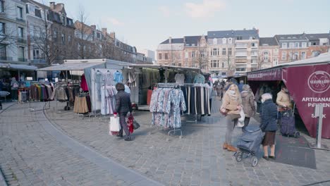 Wide-angle-shot-of-the-marketplace-with-masked-people-in-Leuven,-Belgium