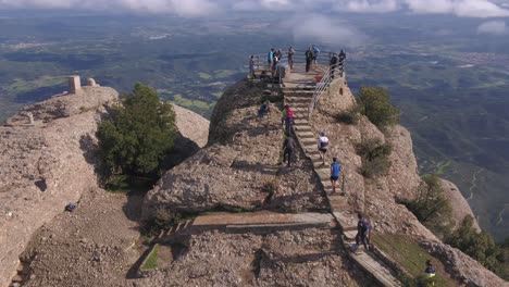 Tourists-Climbing-Stairs-to-Montserrat-Viewing-Deck,-Extraordinary-View-of-Catalonia,-Aerial-Rising