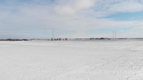 Heavy-snow-covering-countryside-fields-and-electricity-power-lines