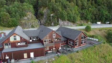 Åkrafjordtunet---Aerial-showing-accomodation-and-restaurant-with-road-E134-in-background---Norway