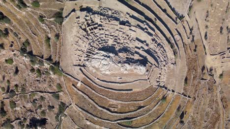 Aerial-bird's-eye-video-taken-by-drone-of-iconic-prehistoric-settlement-of-Skarkos,-Ios-island,-Cyclades,-Greece