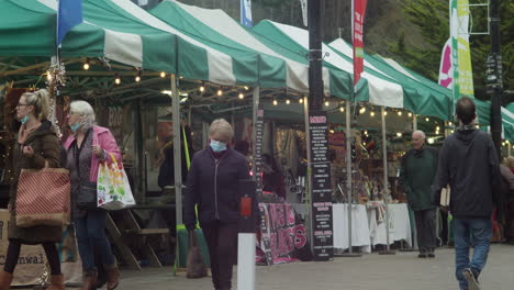 Truro's-Farmers-Market-in-Cornwall-with-People-Walking-Past-Shopping-with-Food-on-Display