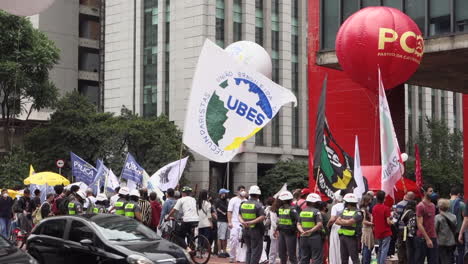 Police-watch-protesters-with-banners-at-Black-Awareness-rally,-Brazil