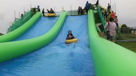 People-Having-Fun-On-Giant-Inflatable-Slide-In-Cornwall,-UK