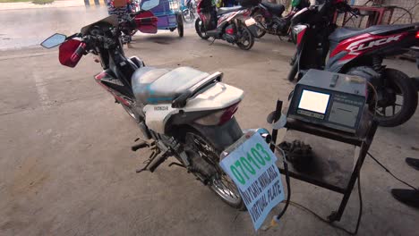 A-shot-of-a-motorcycle-being-tested-by-an-Automotive-Emission-Analyzer