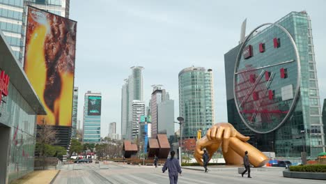 Iconic-golden-Gangnam-hands-statue-at-the-Coex-business-complex-in-Seoul,-South-Korea---establishing-shot
